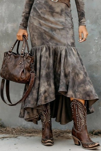A woman wearing a long-sleeved, crewneck mini dress in a brown and grey tie-dye pattern, featuring vertical seams and a fitted silhouette.