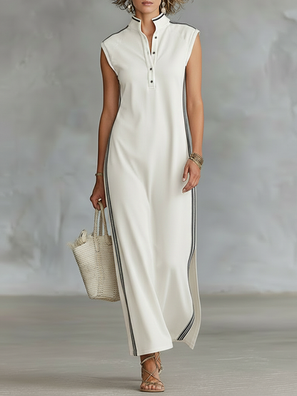 White - Sleeveless collared maxi dress with a front half-button placket, contrast side stripes, and side hem slits, styled with a woven tote bag and strappy sandals.