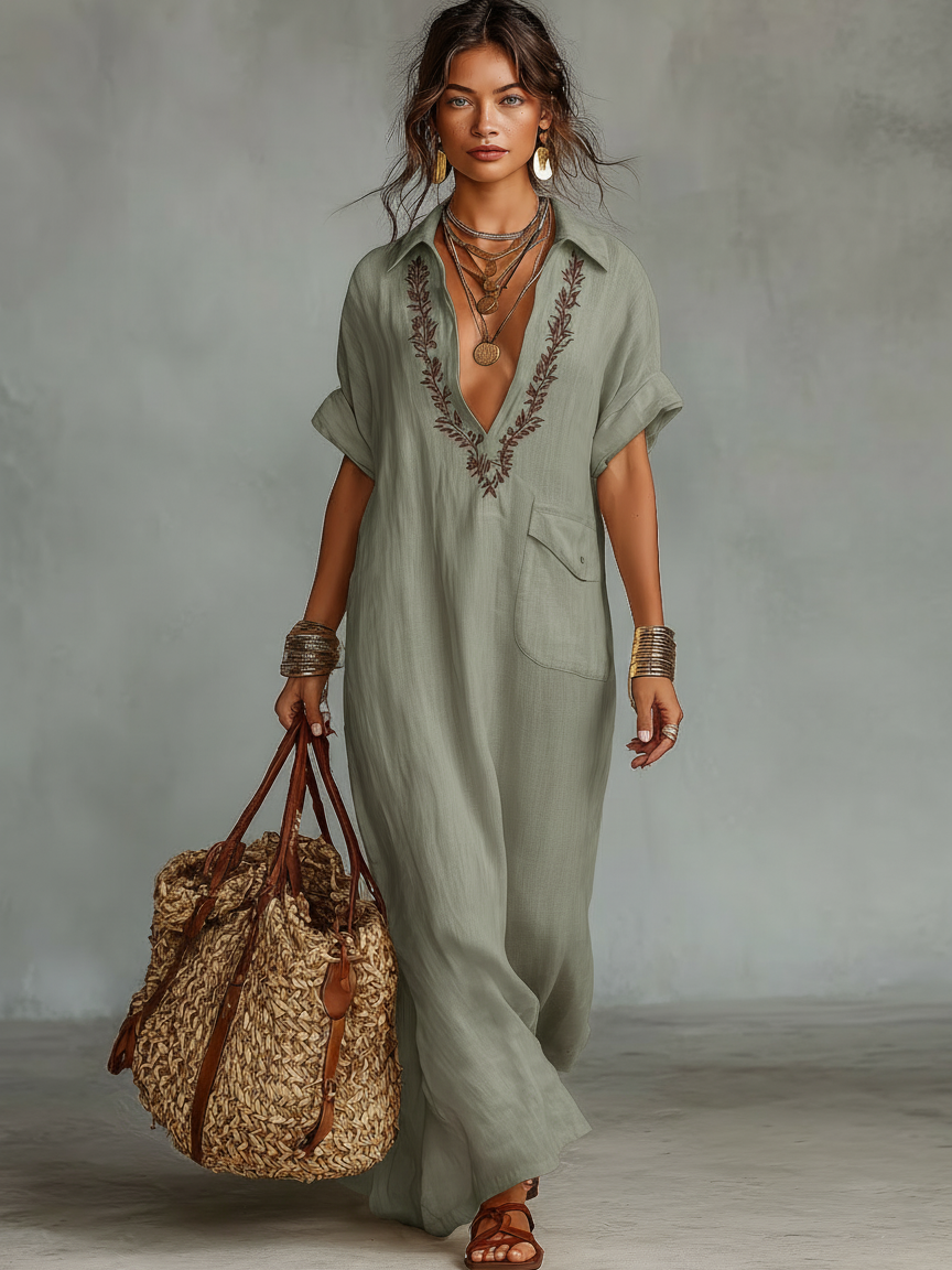 Light Green - Woman wearing a relaxed-fit, floor-length linen maxi dress featuring a deep V-neckline, collar, short sleeves, front patch pocket, and intricate contrast embroidery around the neck.