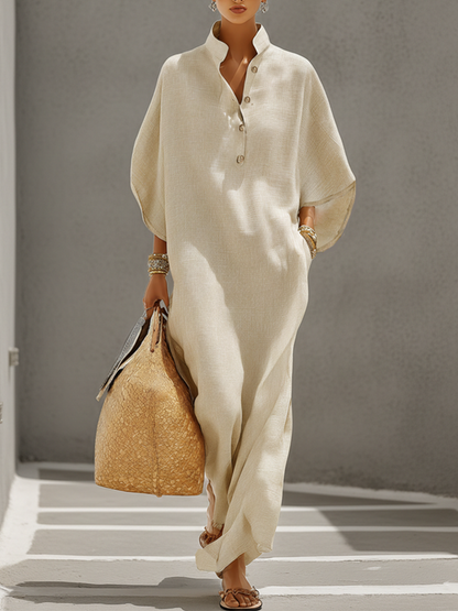 Oatmeal - Woman walking outdoors wearing a relaxed, oversized collared maxi dress with wide sleeves and a front button placket, carrying a woven tote bag.