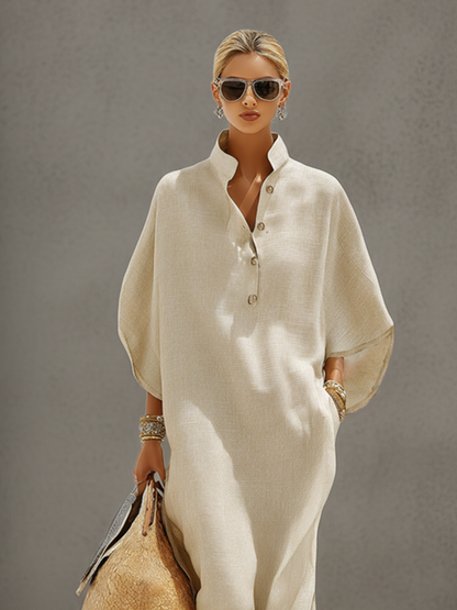Oatmeal - Woman walking outdoors wearing a relaxed, oversized collared maxi dress with wide sleeves and a front button placket, carrying a woven tote bag.