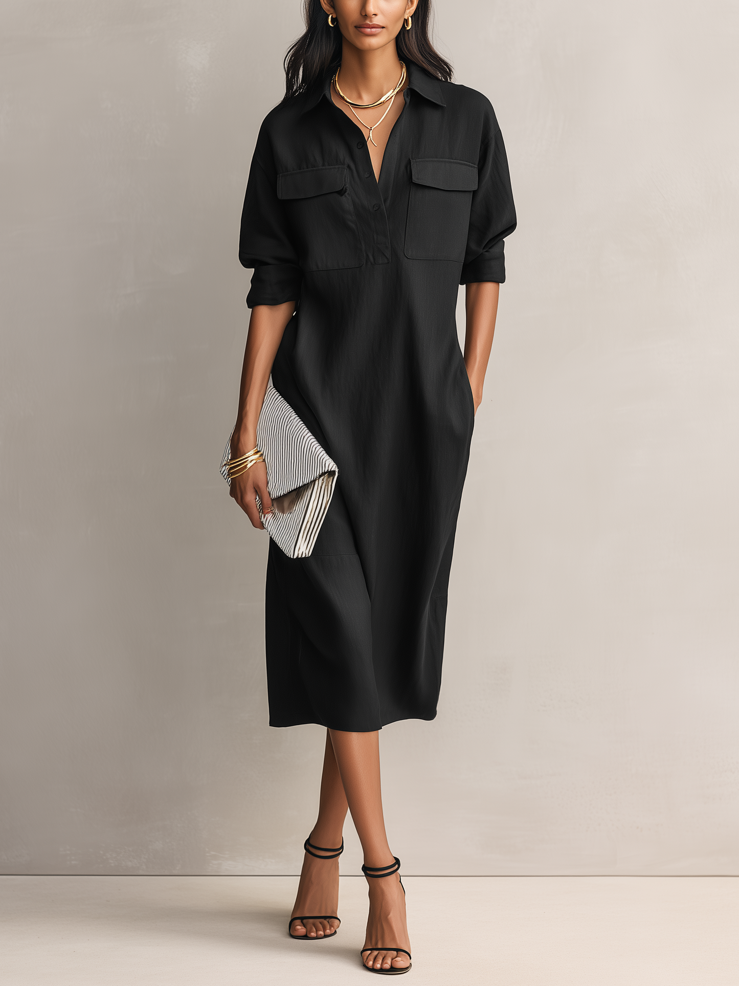 Black - Model wearing a relaxed fit, long-sleeve midi shirtdress with a collar, chest pockets, and side pockets against a neutral background.