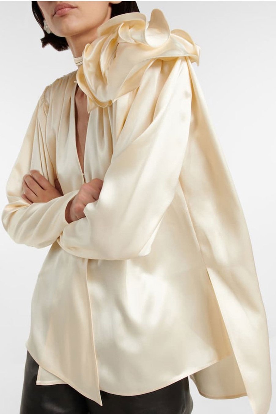 Woman in cream silk satin blouse with ruffle detail