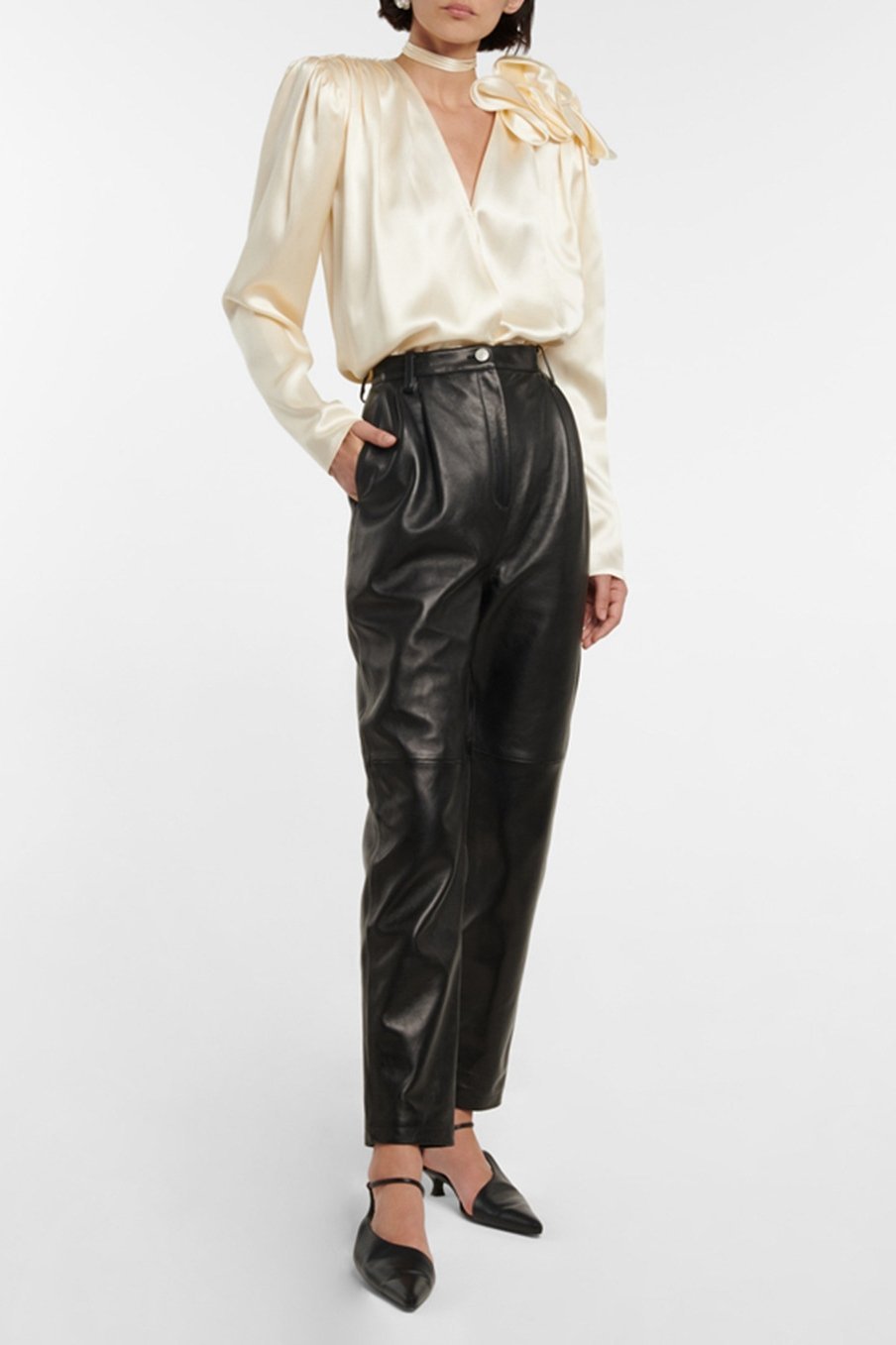 Woman in cream silk satin blouse with ruffle detail