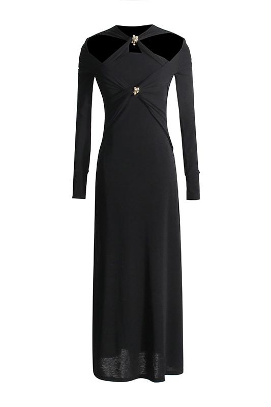 Woman in black ribbed knit midi dress with cold shoulder and gold hardware detail.