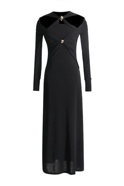 Woman in black ribbed knit midi dress with cold shoulder and gold hardware detail.