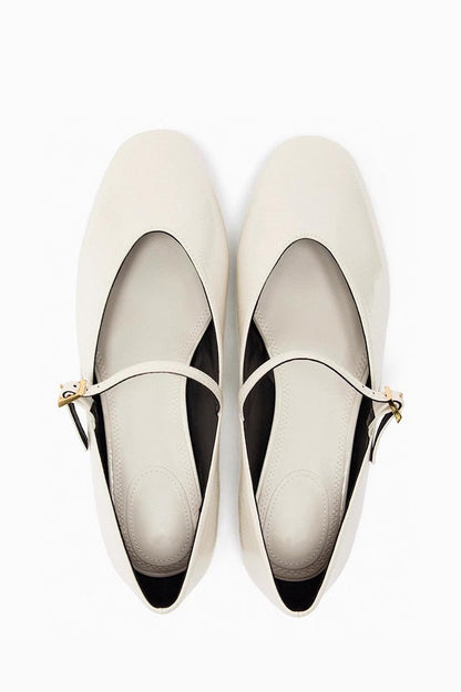 Black - Top-down view of women's black glossy patent Mary Jane flats featuring a thin instep strap and small metallic buckle.