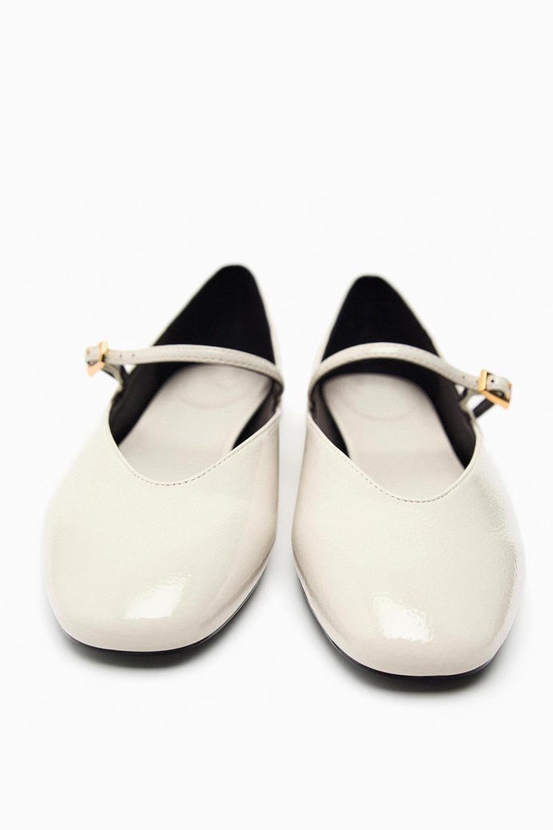 Black - Top-down view of women's black glossy patent Mary Jane flats featuring a thin instep strap and small metallic buckle.