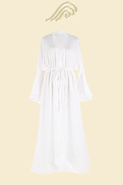 Full length shot of a woman in a terracotta lightweight polyester maxi cover-up with a deep V-neck, button-up front, drawstring waist, and bell sleeves.