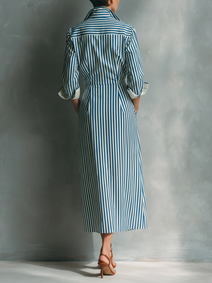 Black And White - Model wearing a striped button-down midi shirtdress with a collar, long sleeves, and a contrast chest pocket.