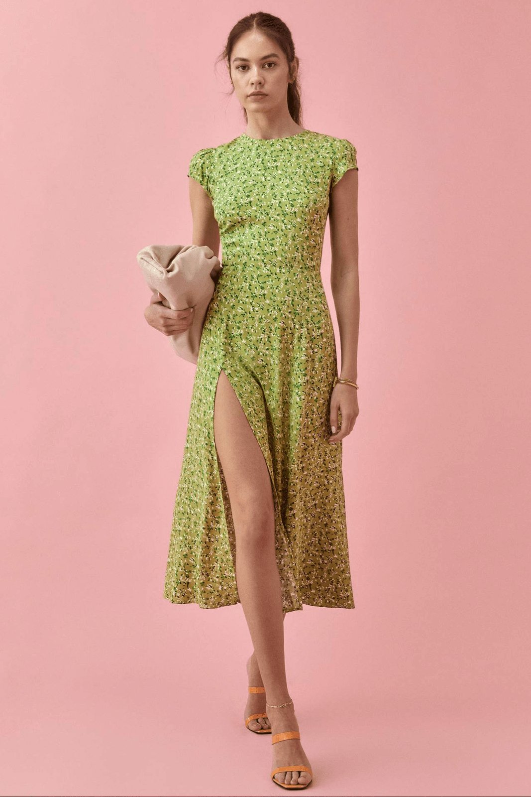 Woman in green floral midi dress with thigh-high slit