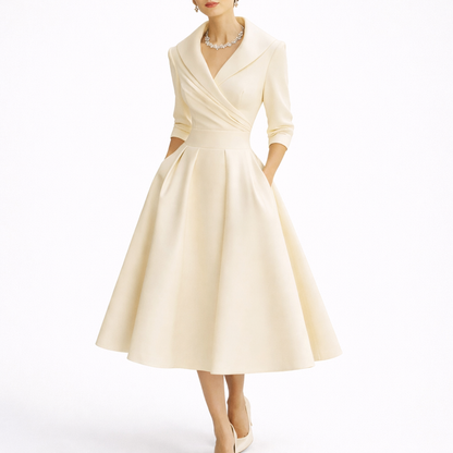 White - Woman wearing a structured A-line midi dress with a wide portrait collar, wrap bodice, 3/4 sleeves, and a full pleated skirt with pockets.