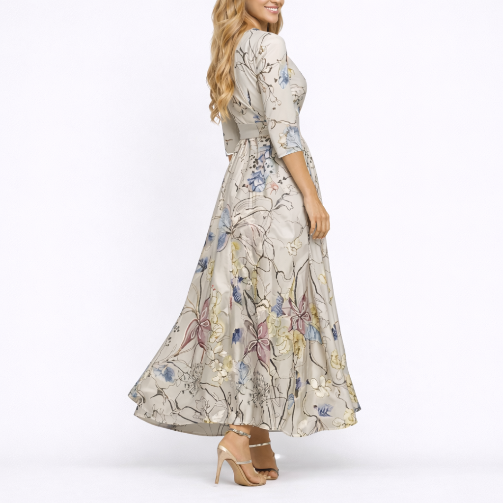Sand & Beige - Woman wearing a satin-finish floral A-line maxi dress with a wrap V-neckline and 3/4 sleeves.