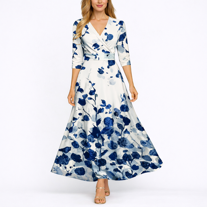 Blue & White - Woman wearing a satin-finish floral A-line maxi dress with a wrap V-neckline and 3/4 sleeves.