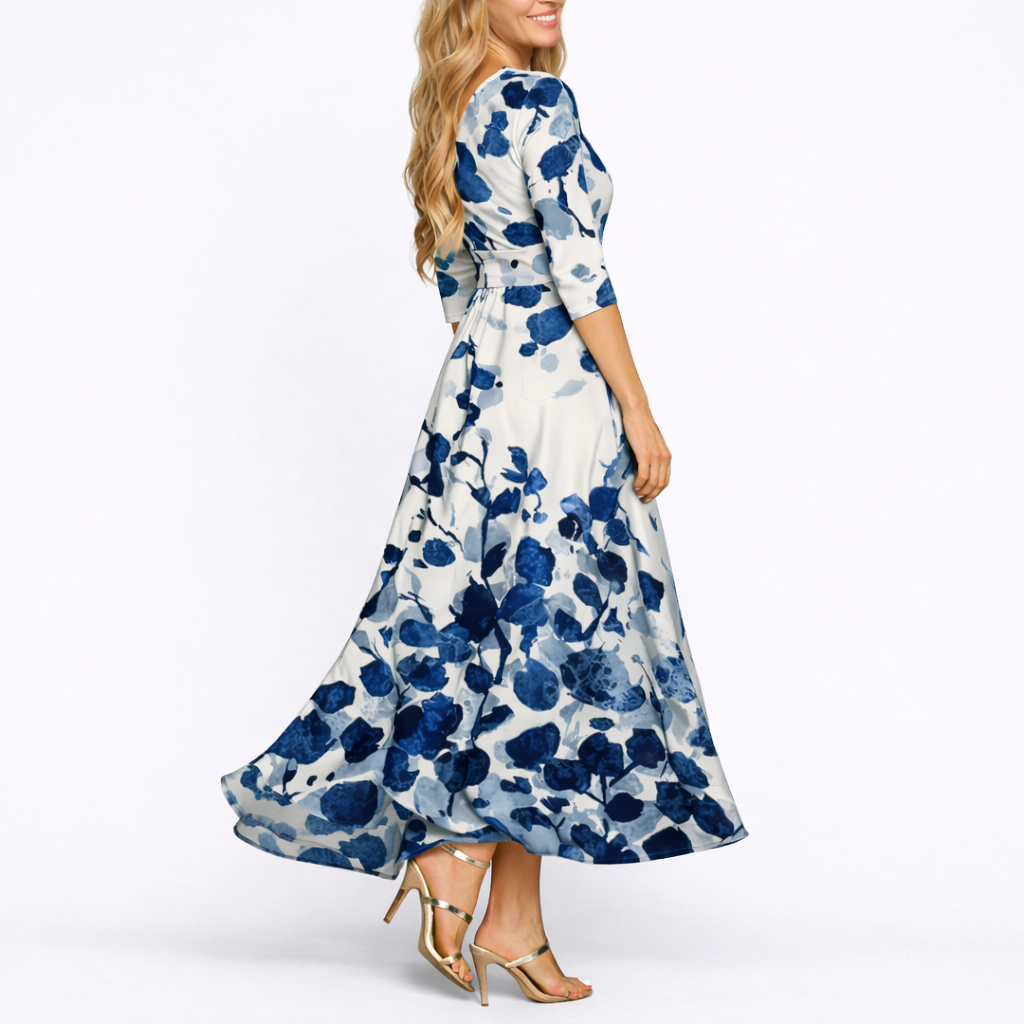 Blue & White - Woman wearing a satin-finish floral A-line maxi dress with a wrap V-neckline and 3/4 sleeves.