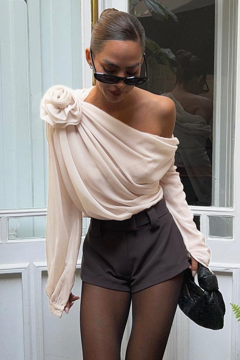 Beige - Women's elegant cream asymmetric blouse featuring a large 3D floral shoulder detail, extensive draped ruching across the bodice, and a single sheer long sleeve.