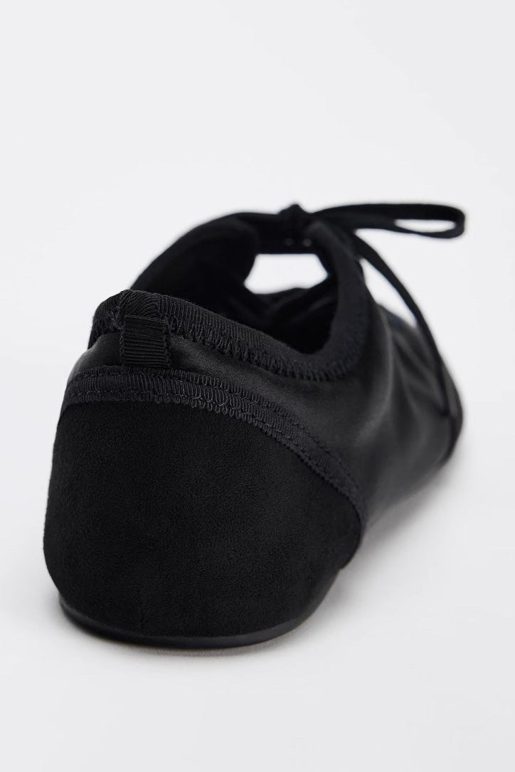 Black - Women's white textured faux leather ballet flats with a delicate tie-front detail, viewed from above.