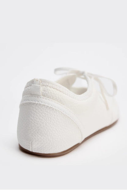 White - Women's white textured faux leather ballet flats with a delicate tie-front detail, viewed from above.