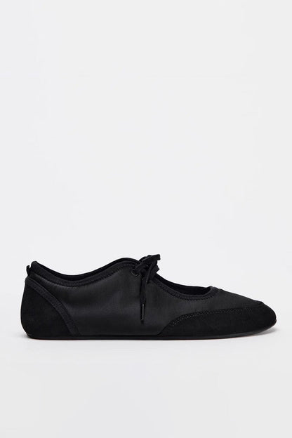 Black - Women's white textured faux leather ballet flats with a delicate tie-front detail, viewed from above.