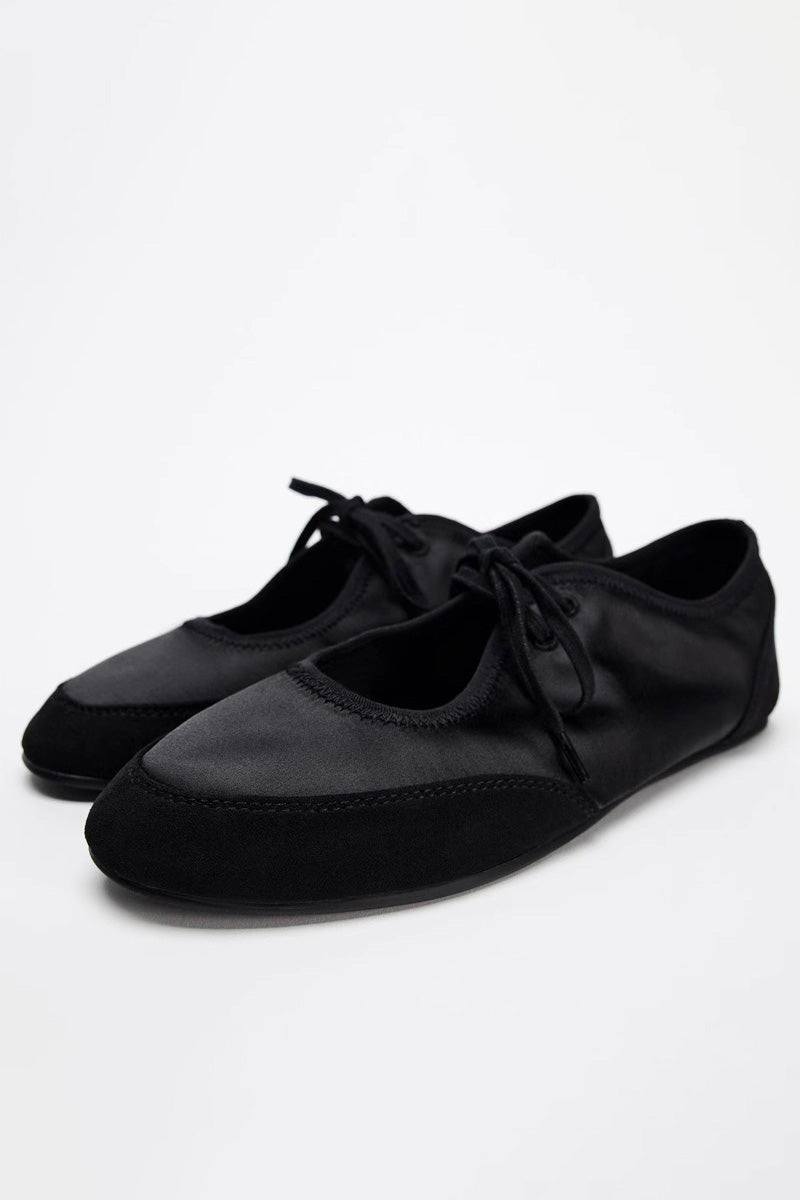 Black - Women's white textured faux leather ballet flats with a delicate tie-front detail, viewed from above.