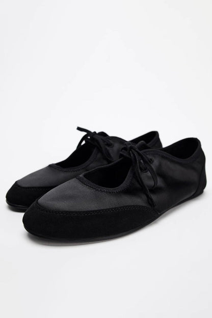 Black - Women's white textured faux leather ballet flats with a delicate tie-front detail, viewed from above.