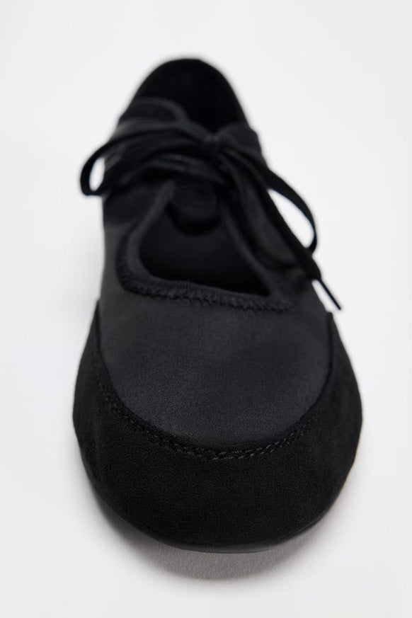 Black - Women's white textured faux leather ballet flats with a delicate tie-front detail, viewed from above.