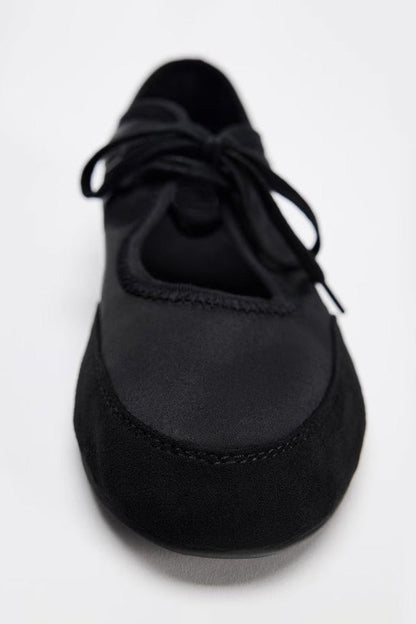 Black - Women's white textured faux leather ballet flats with a delicate tie-front detail, viewed from above.