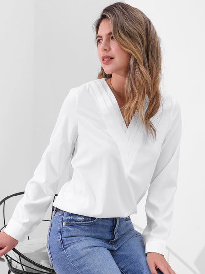 Pink - Women's long-sleeve blouse featuring a distinctive pleated V-neckline and buttoned cuffs, styled tucked into blue denim jeans.