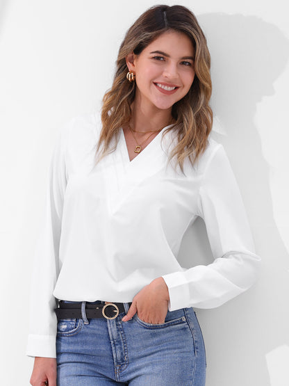 Pink - Women's long-sleeve blouse featuring a distinctive pleated V-neckline and buttoned cuffs, styled tucked into blue denim jeans.