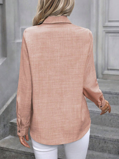 Coral - Women's light green long-sleeve button-down blouse with a collar and textured weave, styled tucked into white trousers.