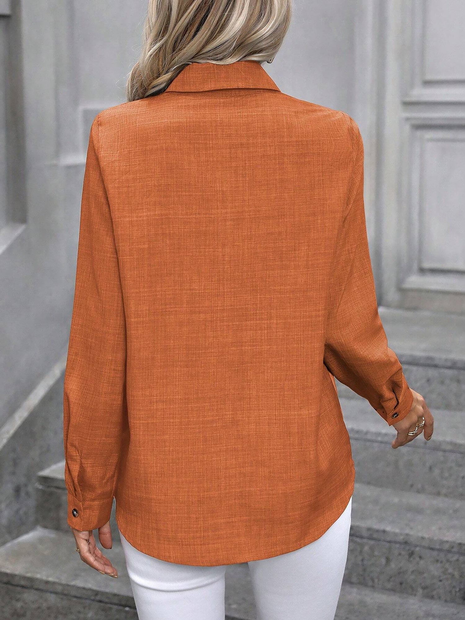 Orange - Women's light green long-sleeve button-down blouse with a collar and textured weave, styled tucked into white trousers.
