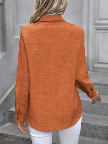 Orange - Women's light green long-sleeve button-down blouse with a collar and textured weave, styled tucked into white trousers.