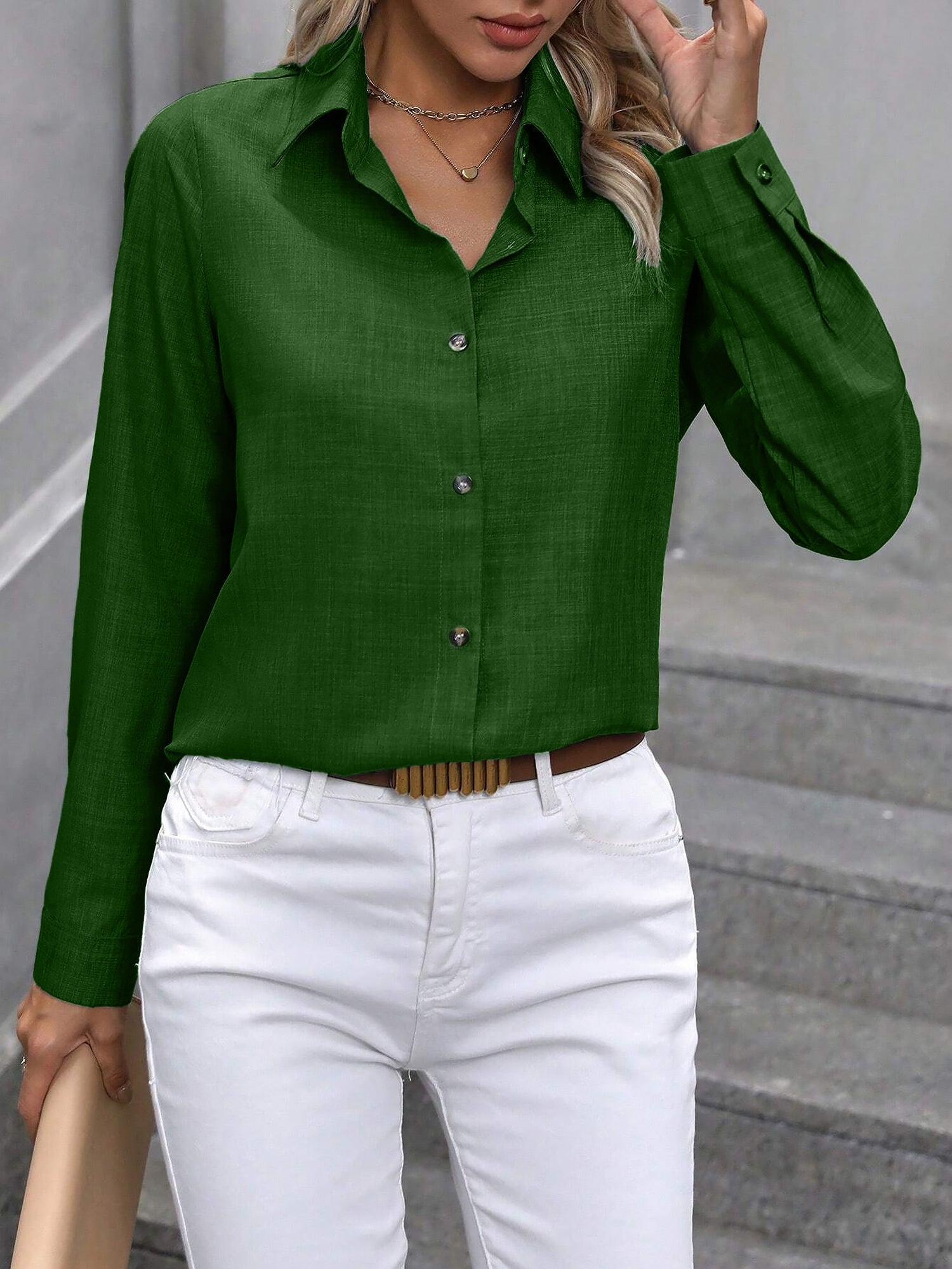 Olive - Women's light green long-sleeve button-down blouse with a collar and textured weave, styled tucked into white trousers.