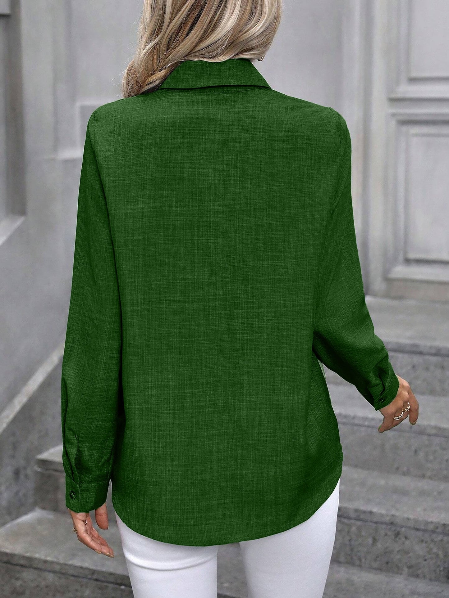 Olive - Women's light green long-sleeve button-down blouse with a collar and textured weave, styled tucked into white trousers.