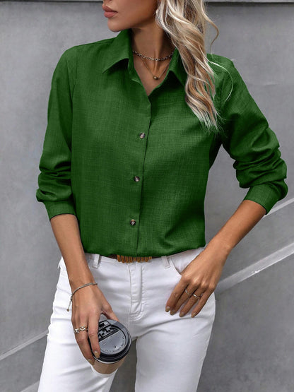 Olive - Women's light green long-sleeve button-down blouse with a collar and textured weave, styled tucked into white trousers.