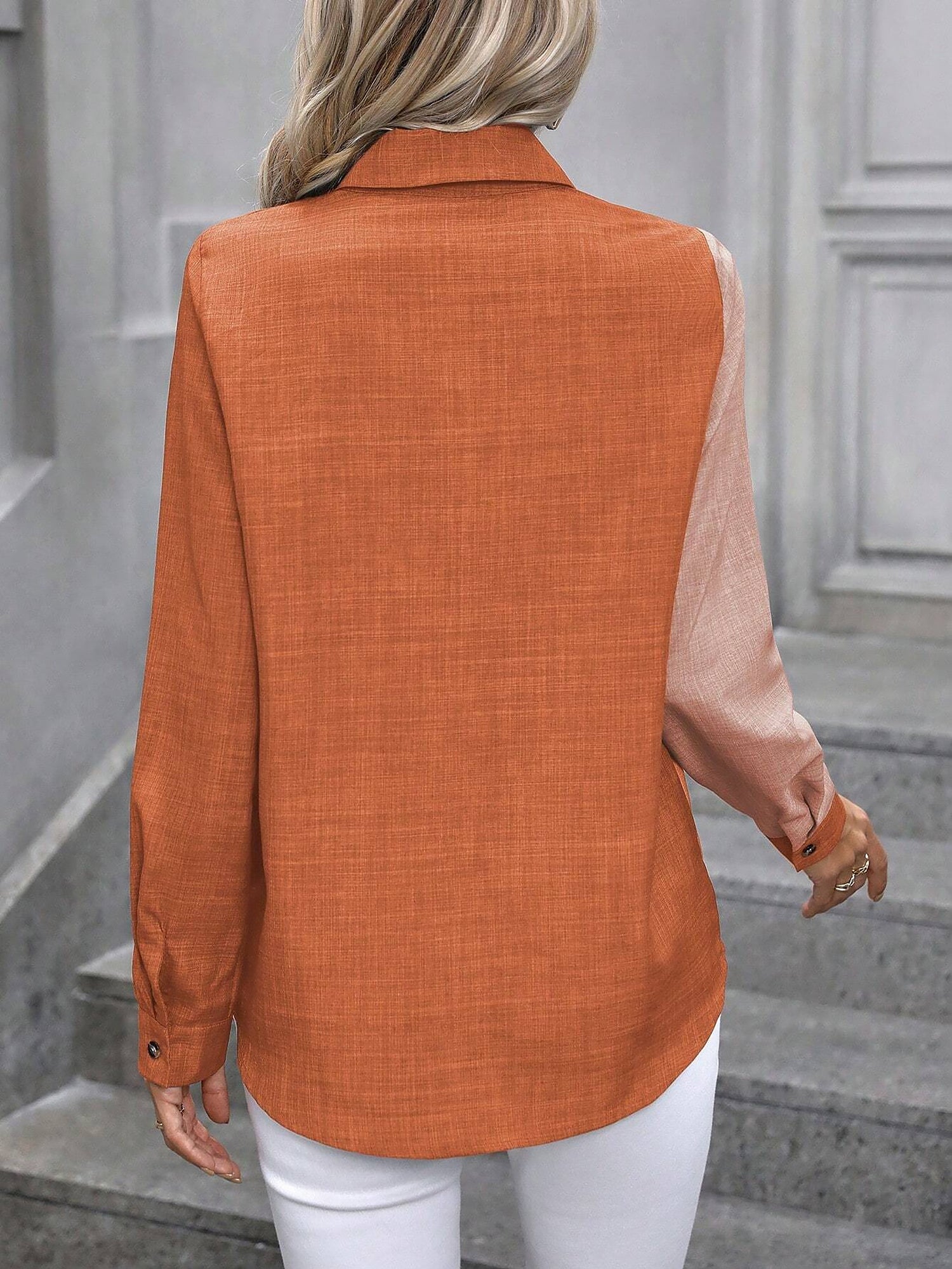 Peach Orange - Women's light green long-sleeve button-down blouse with a collar and textured weave, styled tucked into white trousers.
