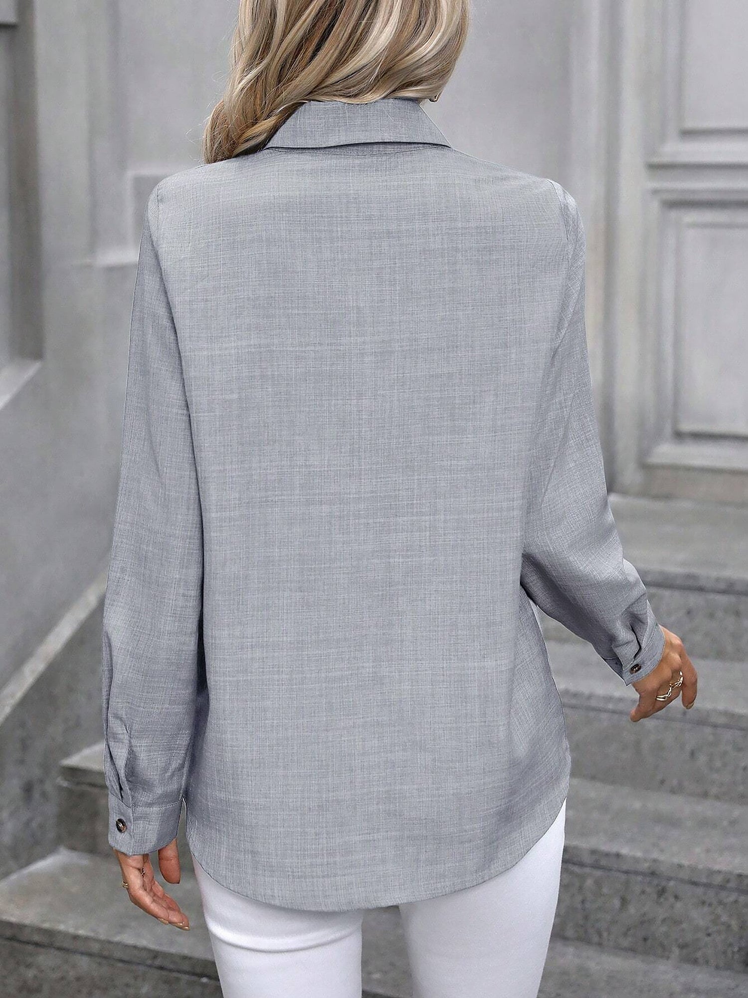 Light Grey - Women's light green long-sleeve button-down blouse with a collar and textured weave, styled tucked into white trousers.