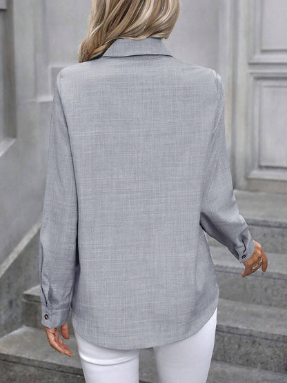 Light Grey - Women's light green long-sleeve button-down blouse with a collar and textured weave, styled tucked into white trousers.