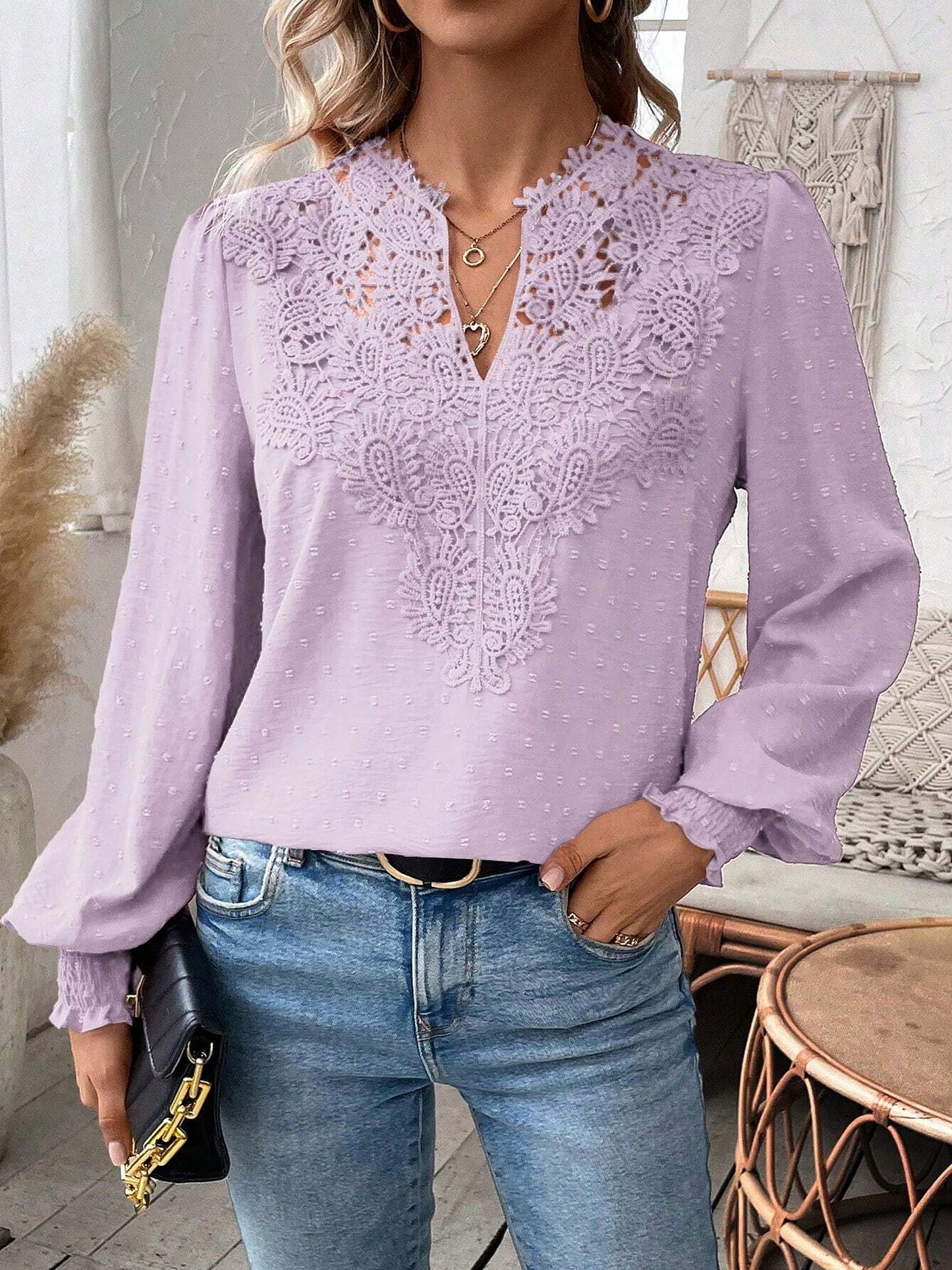 Lavender - Women's dusty rose long-sleeve blouse featuring a lace V-neckline, textured Swiss dot fabric, and smocked cuffs, styled with blue jeans.