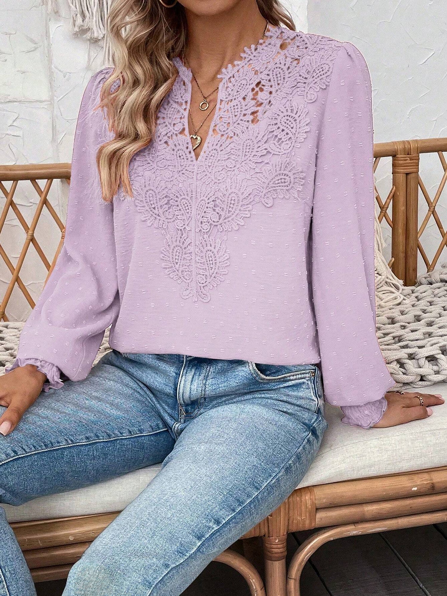 Lavender - Women's dusty rose long-sleeve blouse featuring a lace V-neckline, textured Swiss dot fabric, and smocked cuffs, styled with blue jeans.