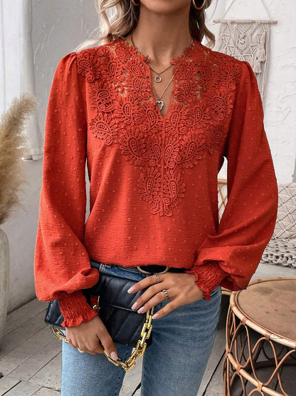 Red - Women's dusty rose long-sleeve blouse featuring a lace V-neckline, textured Swiss dot fabric, and smocked cuffs, styled with blue jeans.