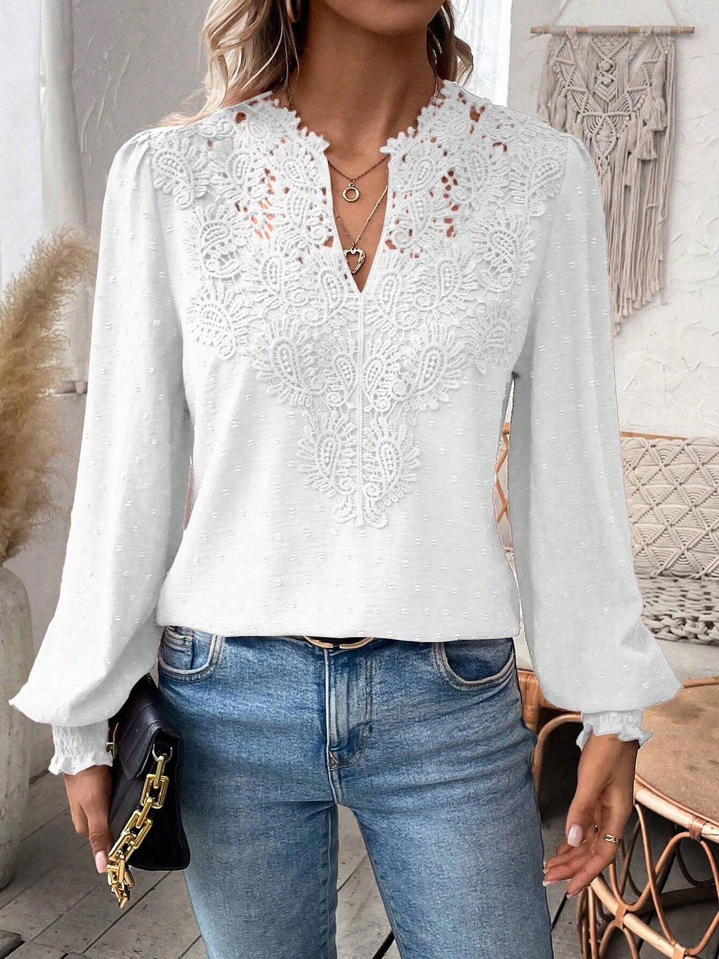 White - Women's dusty rose long-sleeve blouse featuring a lace V-neckline, textured Swiss dot fabric, and smocked cuffs, styled with blue jeans.