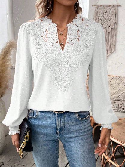 White - Women's dusty rose long-sleeve blouse featuring a lace V-neckline, textured Swiss dot fabric, and smocked cuffs, styled with blue jeans.
