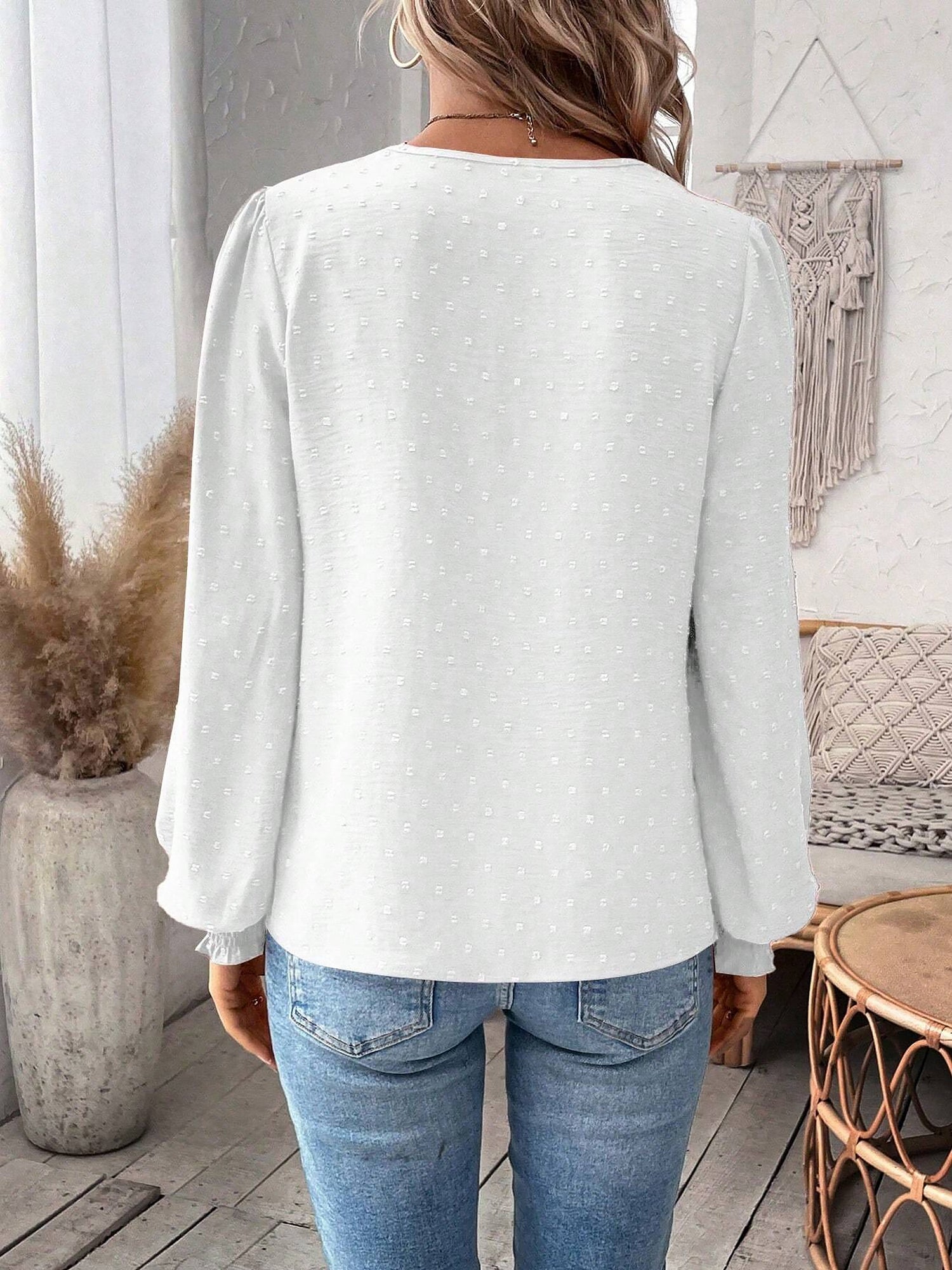 White - Women's dusty rose long-sleeve blouse featuring a lace V-neckline, textured Swiss dot fabric, and smocked cuffs, styled with blue jeans.