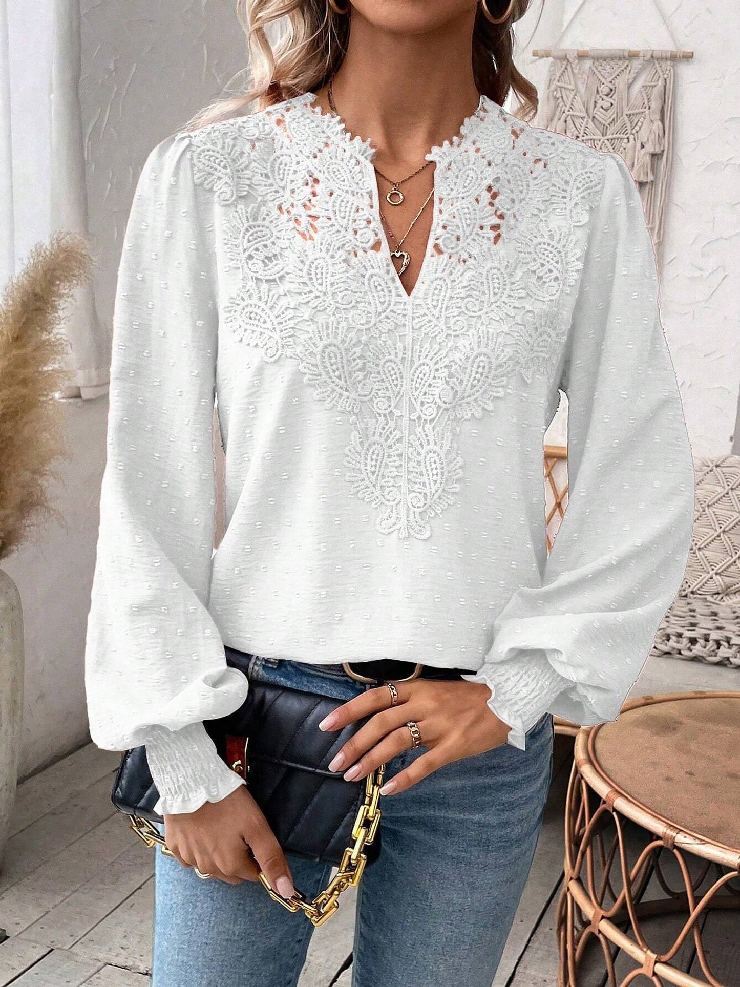 White - Women's dusty rose long-sleeve blouse featuring a lace V-neckline, textured Swiss dot fabric, and smocked cuffs, styled with blue jeans.