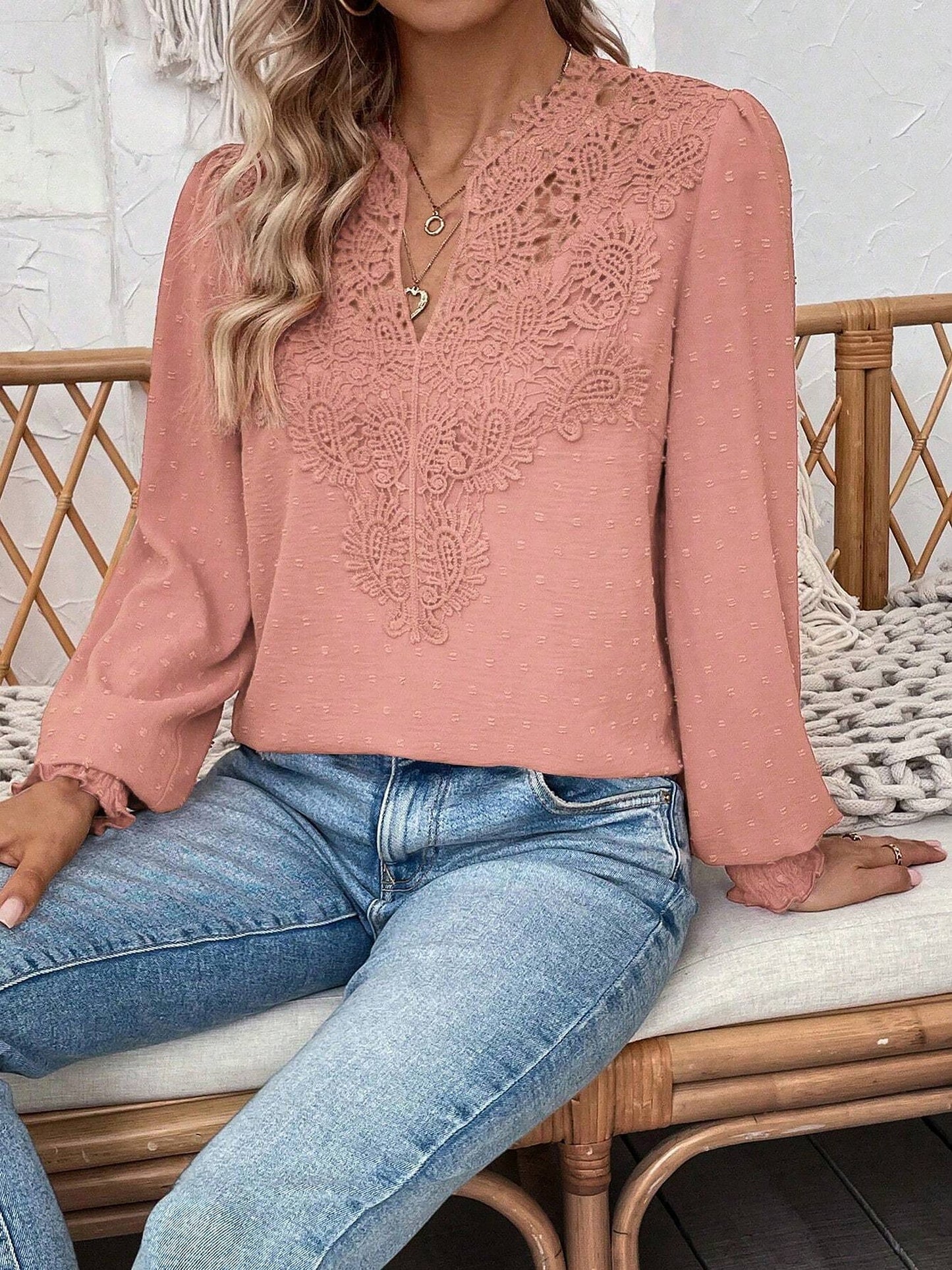Pink - Women's dusty rose long-sleeve blouse featuring a lace V-neckline, textured Swiss dot fabric, and smocked cuffs, styled with blue jeans.