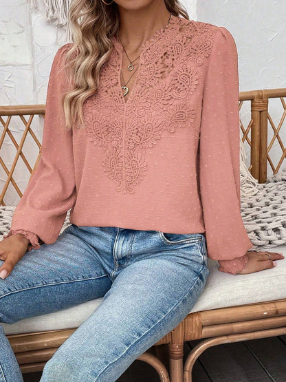 Pink - Women's dusty rose long-sleeve blouse featuring a lace V-neckline, textured Swiss dot fabric, and smocked cuffs, styled with blue jeans.