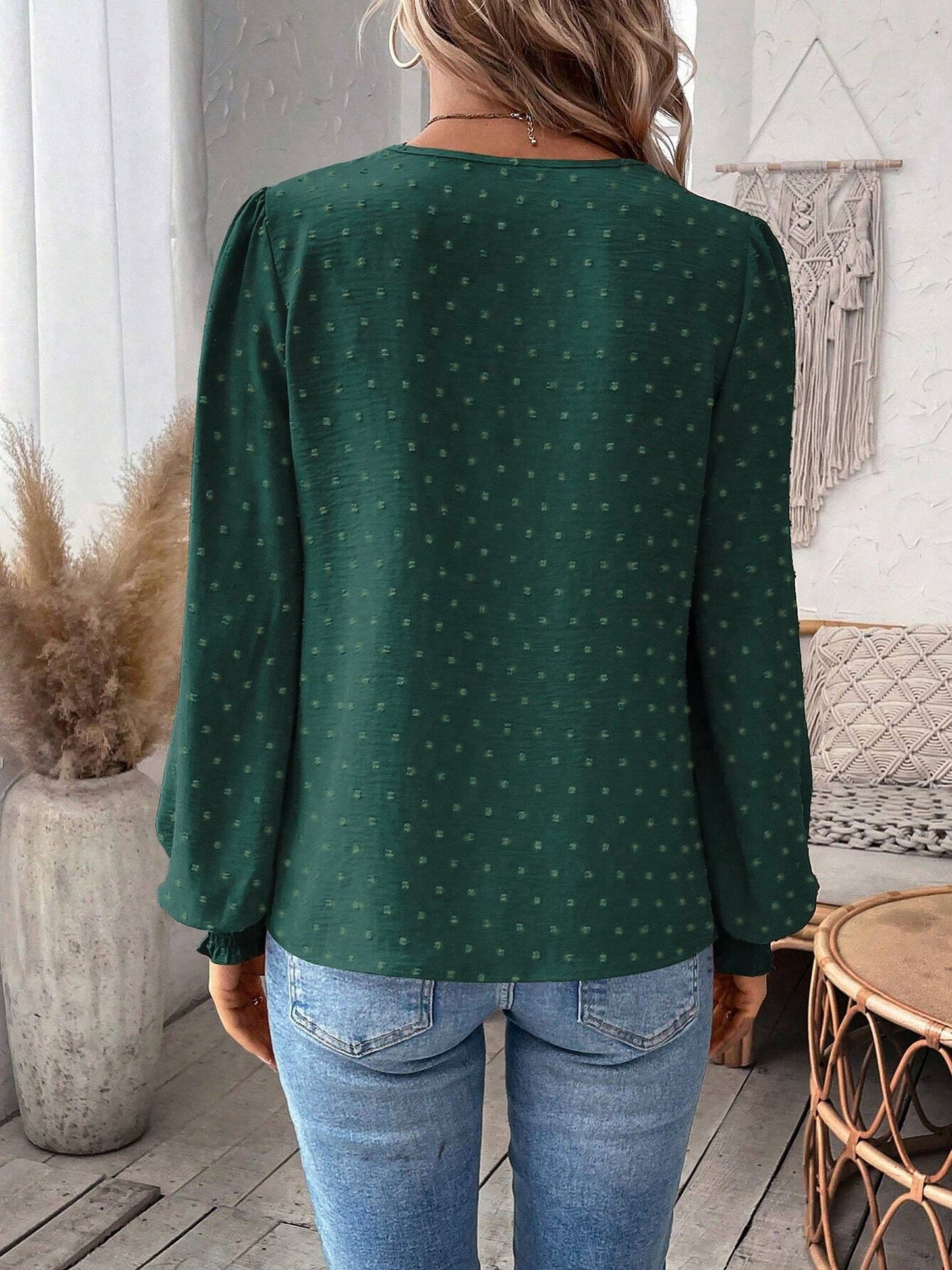 Green - Women's dusty rose long-sleeve blouse featuring a lace V-neckline, textured Swiss dot fabric, and smocked cuffs, styled with blue jeans.