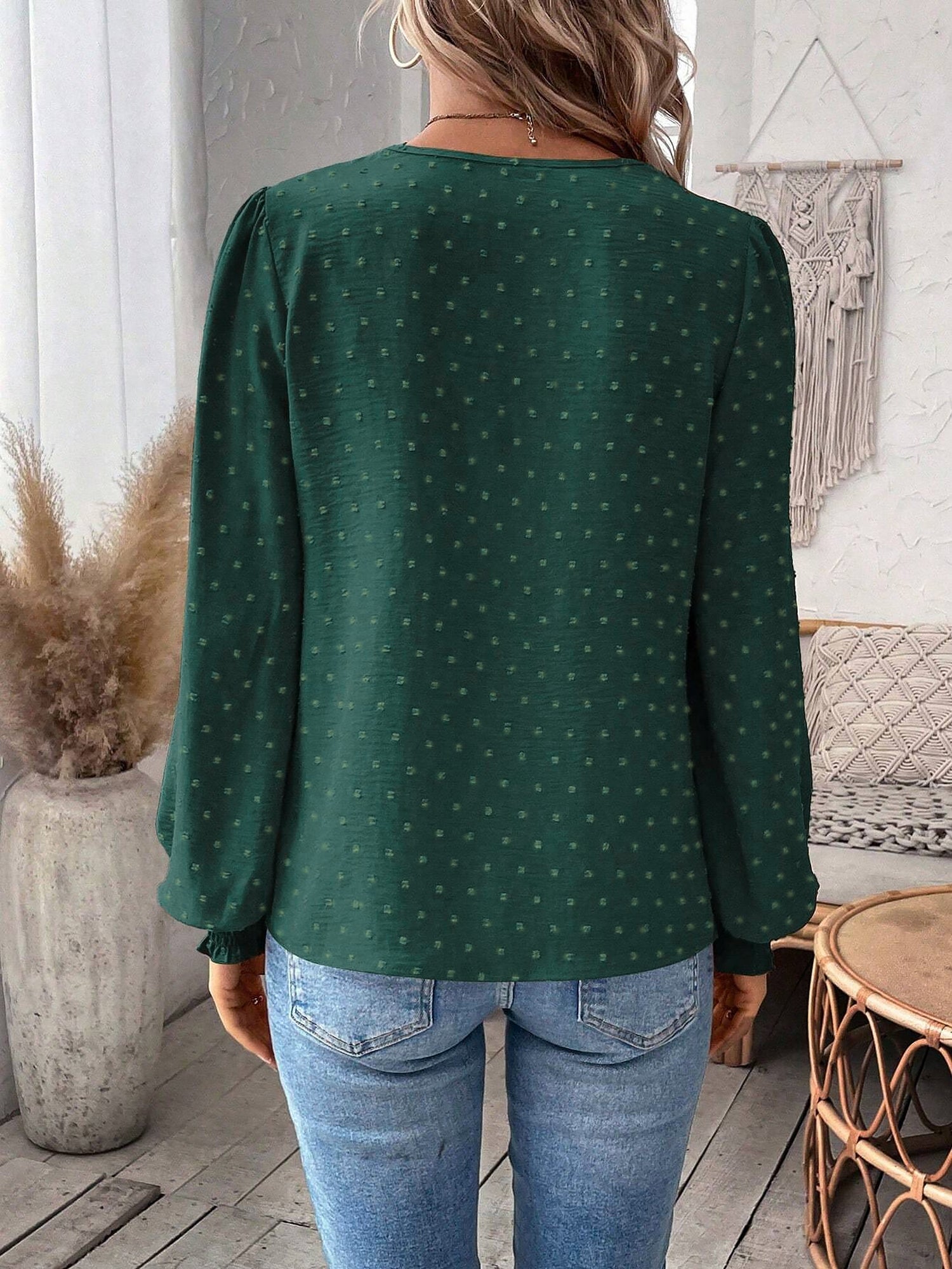Green - Women's dusty rose long-sleeve blouse featuring a lace V-neckline, textured Swiss dot fabric, and smocked cuffs, styled with blue jeans.