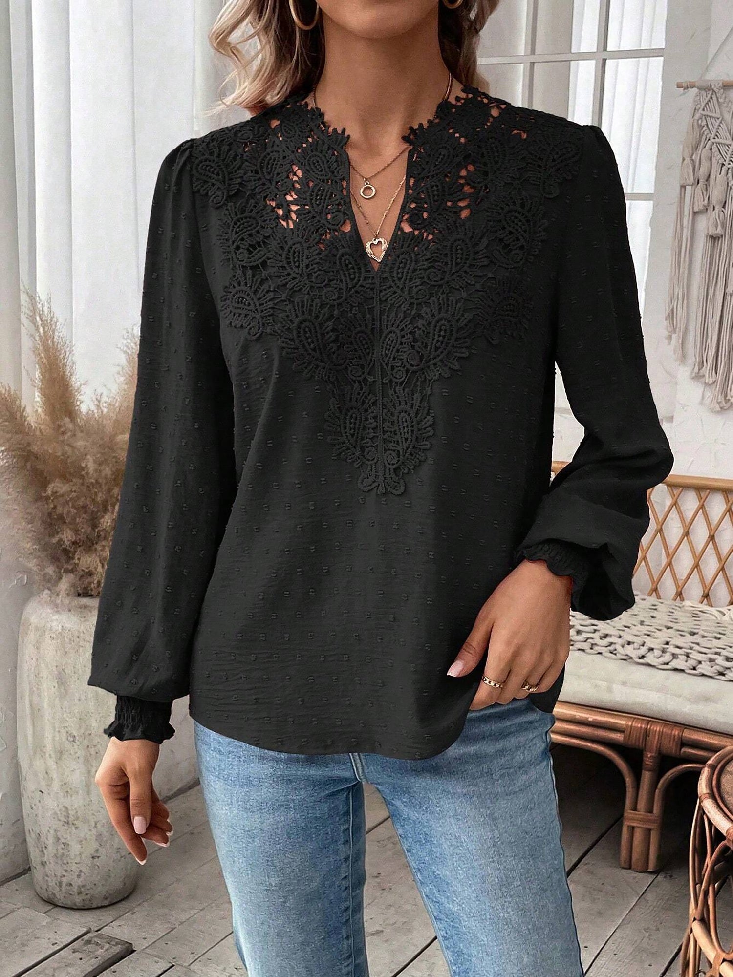 Black - Women's dusty rose long-sleeve blouse featuring a lace V-neckline, textured Swiss dot fabric, and smocked cuffs, styled with blue jeans.